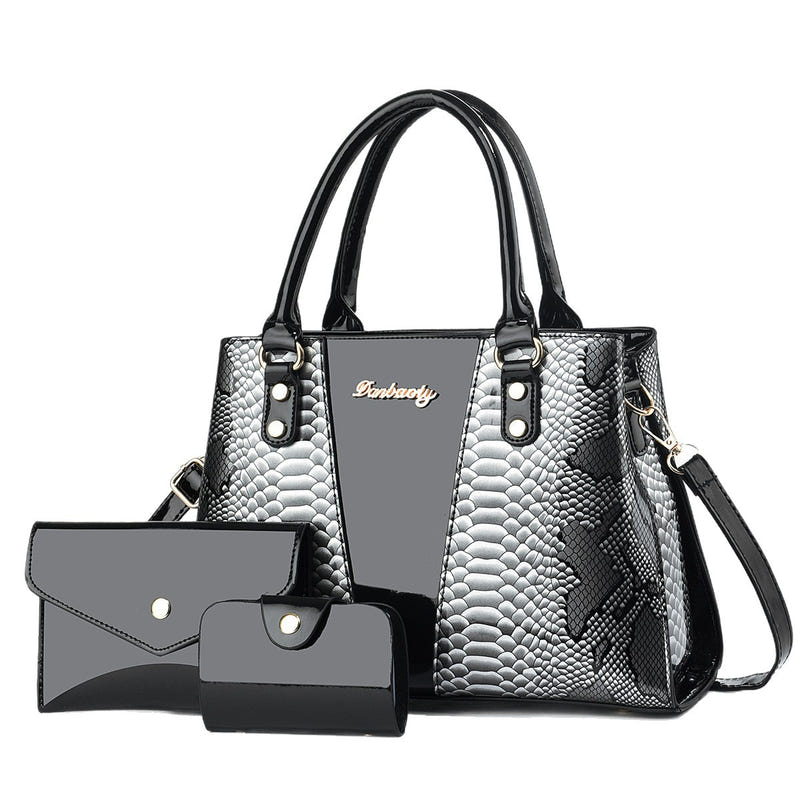 Black-and-silver shoulder tote bag with scalloped texture, front pocket, and wallet