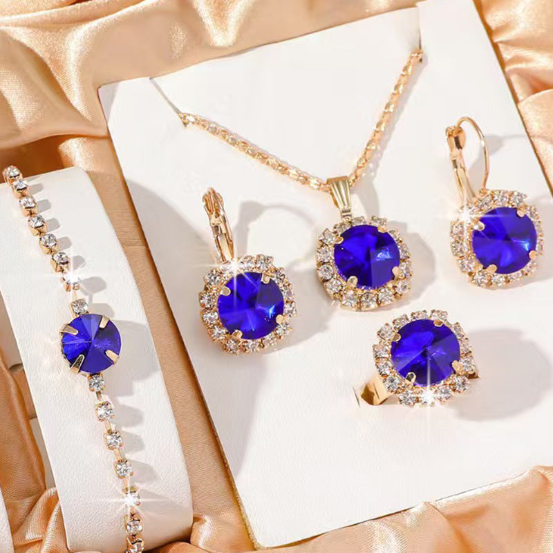 Jewelry set with blue gemstones on a white box with gold accents