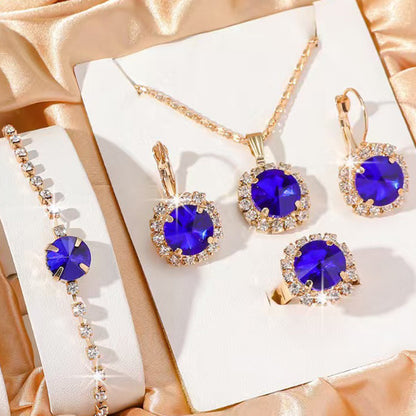 Jewelry set with blue gemstones on a white box with gold accents