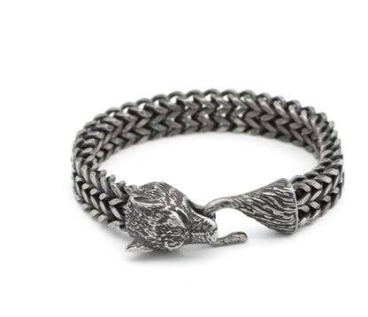 Silver chain bracelet with a fox clasp on a white background