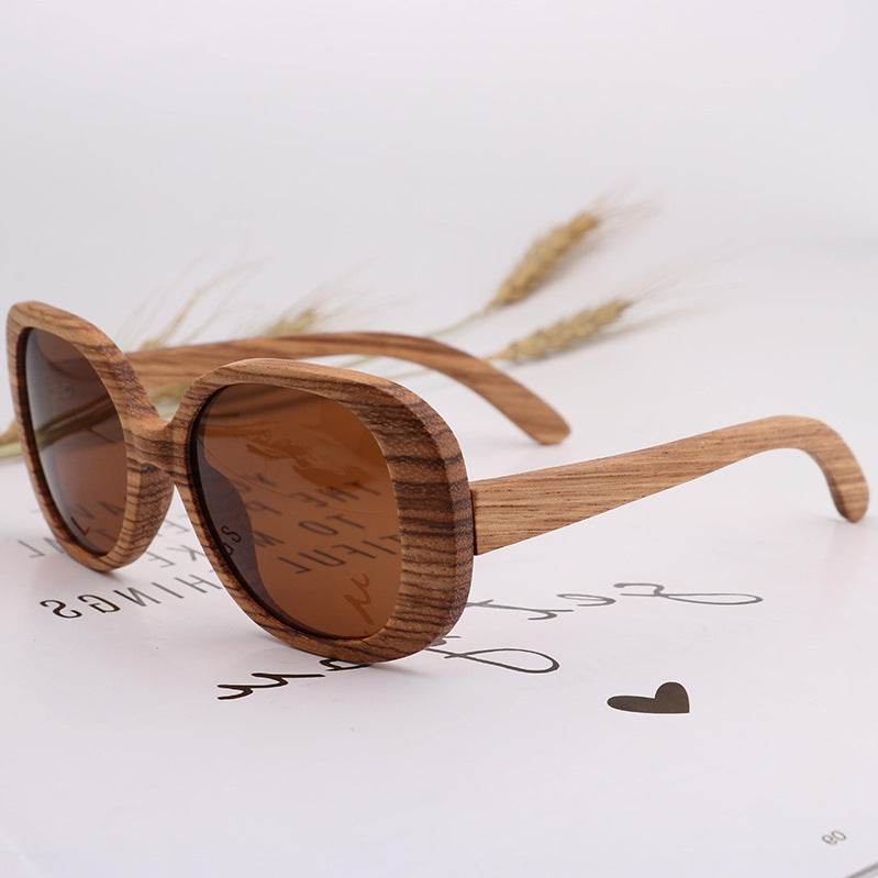 Wooden sunglasses with brown lenses on a light background