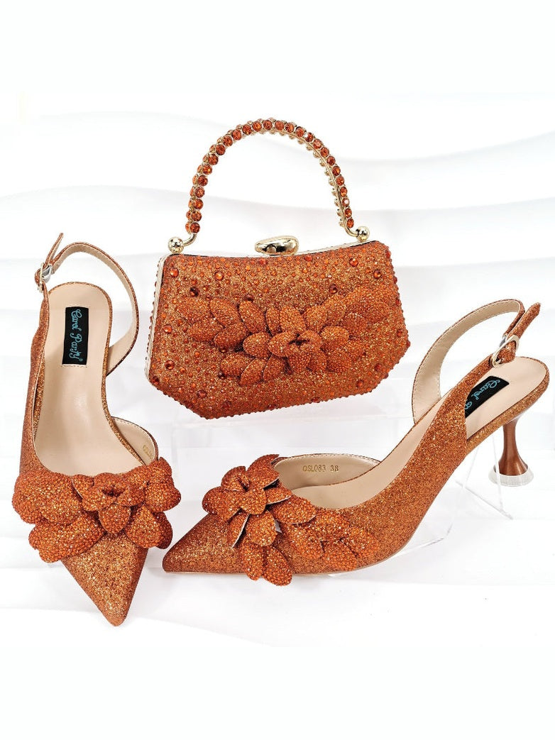 Pair of orange glittery high-heeled shoes with matching handbag on a white background