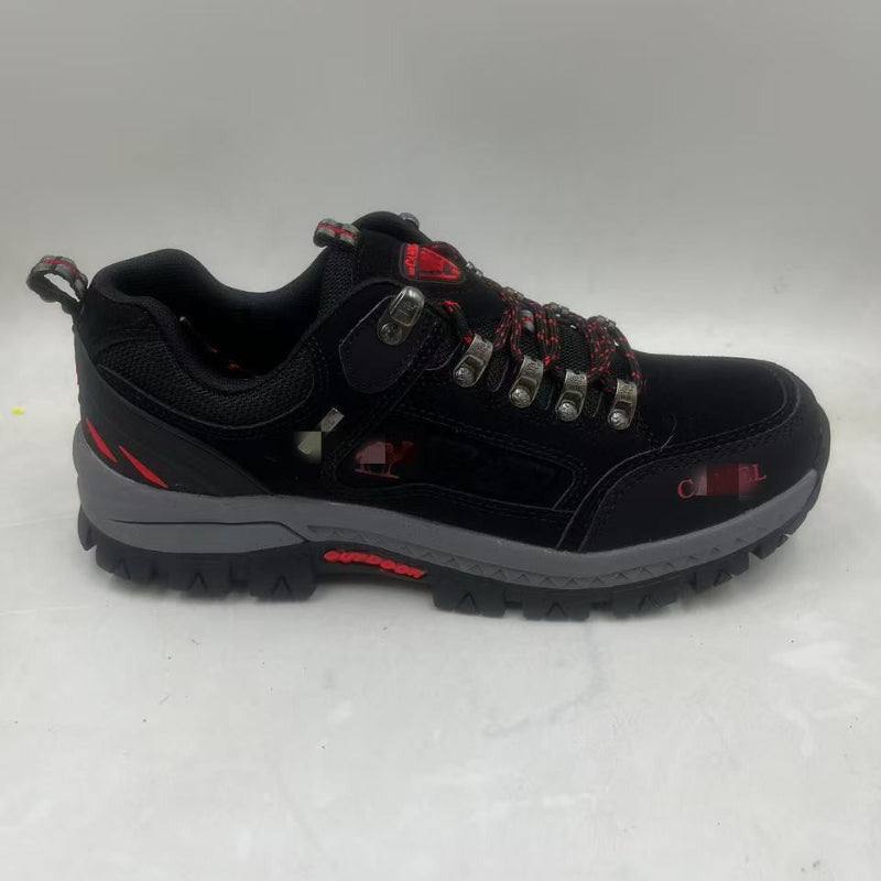Black hiking shoe with red accents on a white background