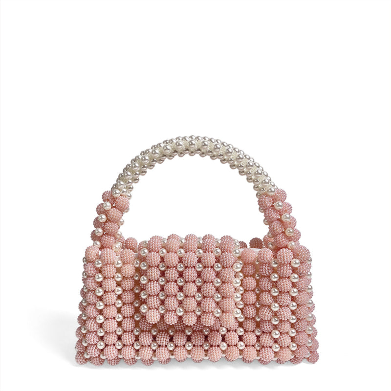 Pink beaded handbag with pearl handle on a white background