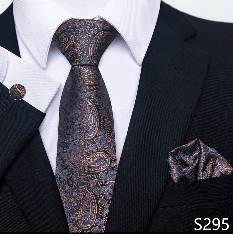 Black suit with a patterned tie and pocket square on a white shirt.