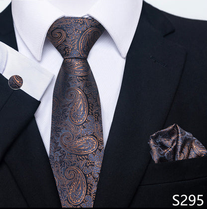 Black suit with a patterned tie and pocket square on a white shirt.