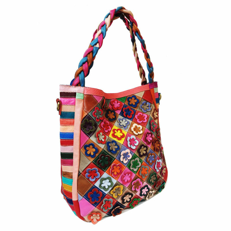 Colorful patchwork handbag with braided handle on a white background