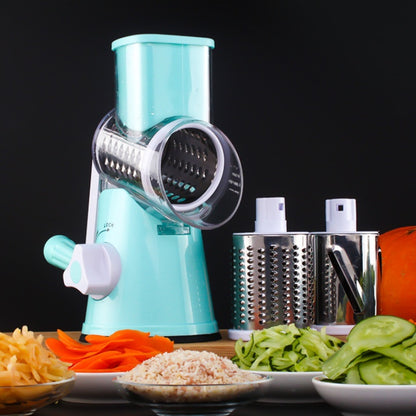 Turquoise manual vegetable spiralizer with sliced vegetables on a black background