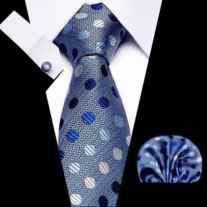 Blue patterned tie with matching pocket square on a black and white background