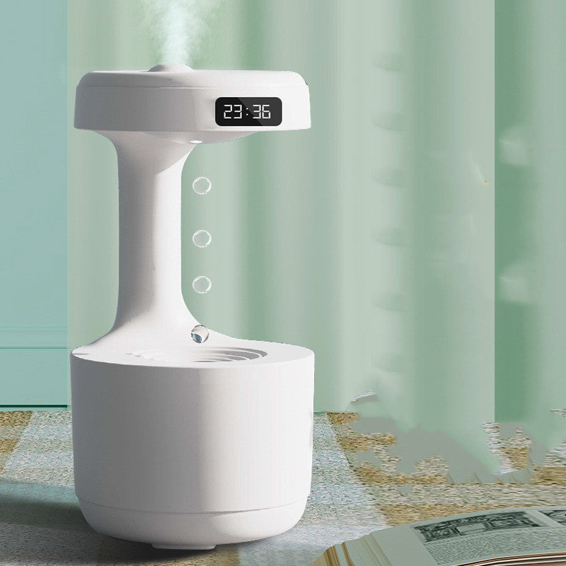 White humidifier with digital display on a table with a light green curtain background