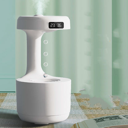 White humidifier with digital display on a table with a light green curtain background