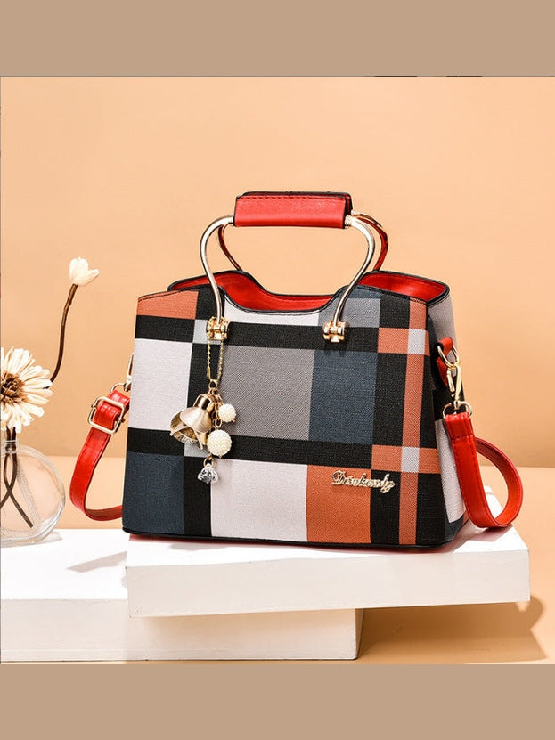 Plaid pattern handbag with red accents on a beige background