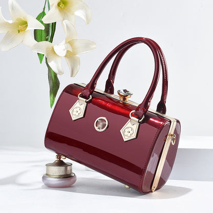 Red handbag with gold accents on a white background with flowers