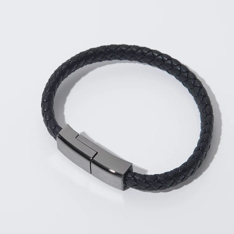Black braided bracelet charging cable with metal clasp, close-up
