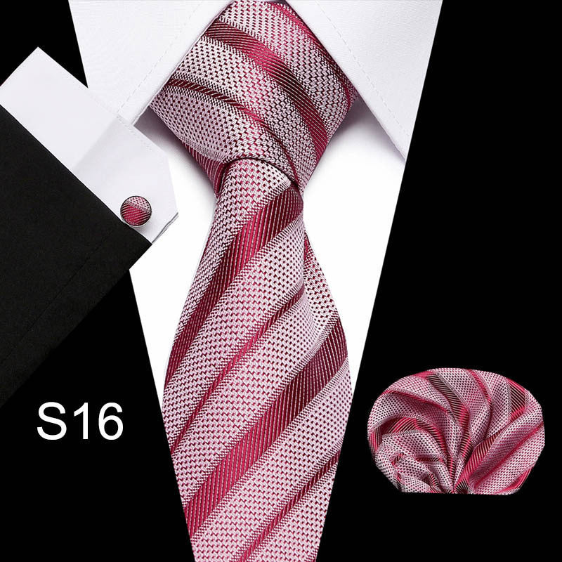 Pink and white striped tie set with pocket square and cufflinks on a black background