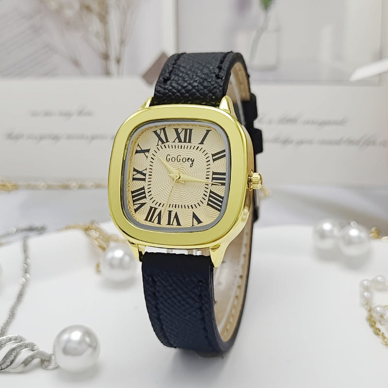 Gold watch with black strap on a white background