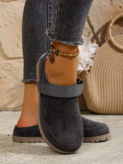 Black round-toe slip-on flats with side strap and bead ankle bracelet
