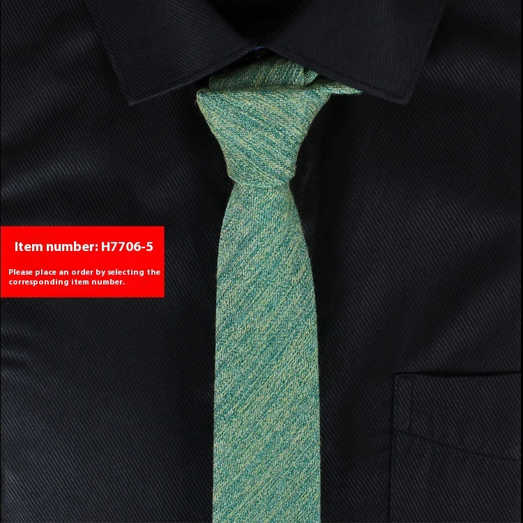 Green tie on a black shirt with a red item number label.