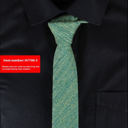 Green tie on a black shirt with a red item number label.