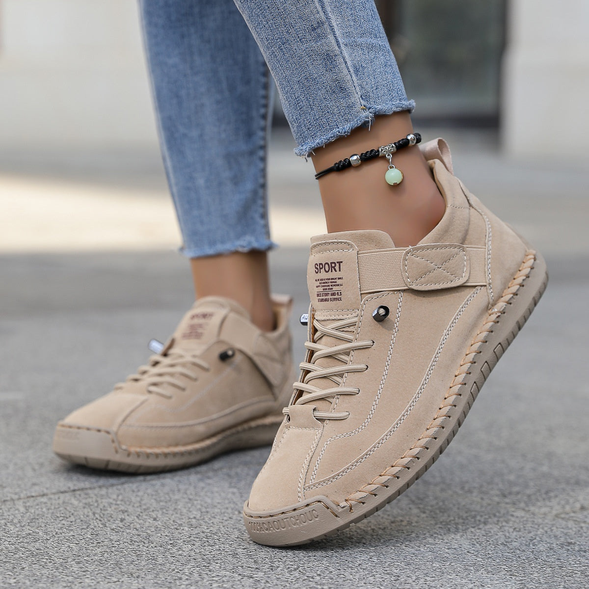 Men's mid-top lace-up leather shoe in beige with strap accents and grippy outsole.