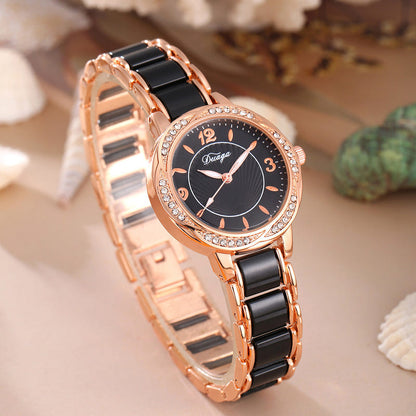 Rose gold round quartz wristwatch with dark dial and black link bracelet