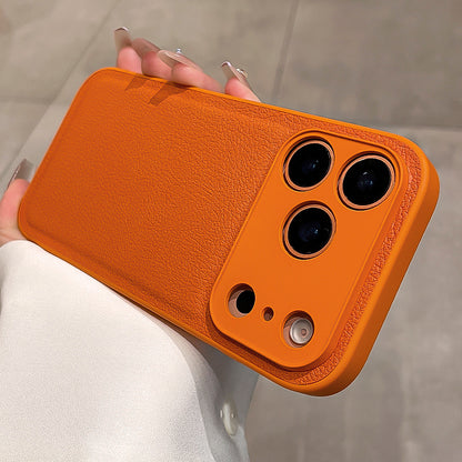 Orange phone case held by a person with a neutral background