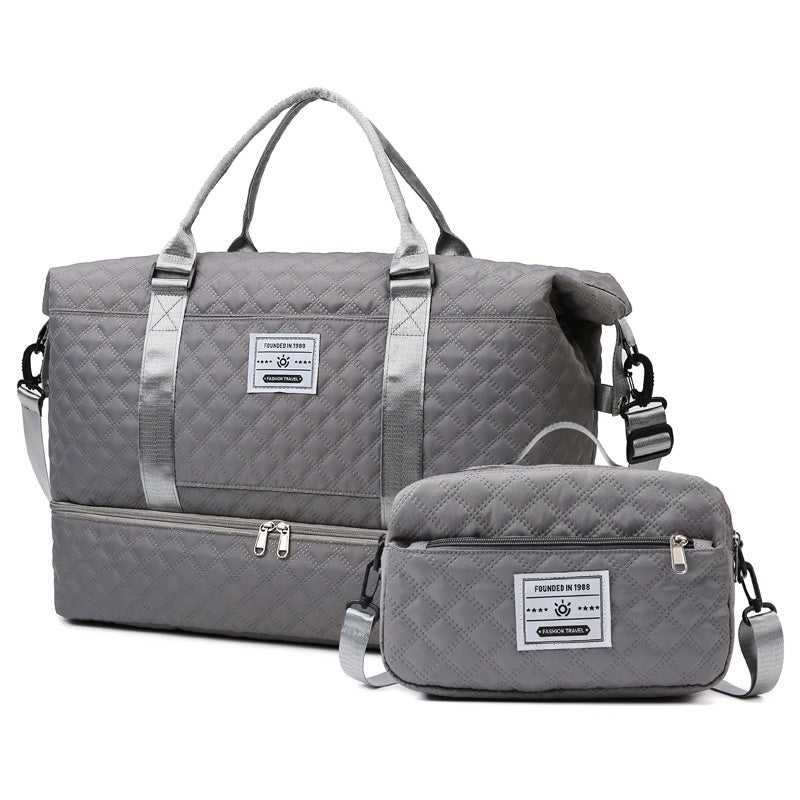 Dark gray quilted travel bag with shoulder strap and matching crossbody pouch