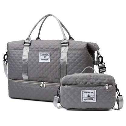 Dark gray quilted travel bag with shoulder strap and matching crossbody pouch