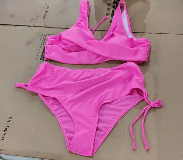Pink bikini set on a cardboard surface