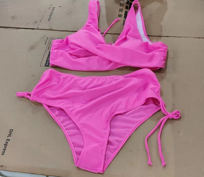 Pink bikini set on a cardboard surface