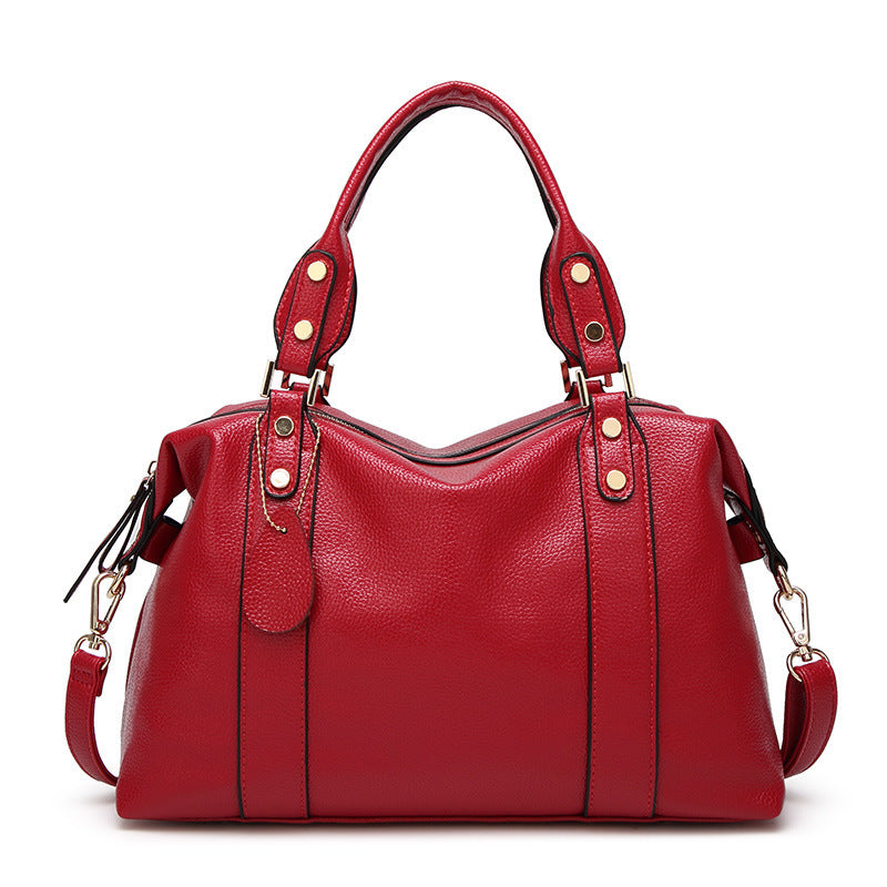 Red handbag with gold accents on a white background
