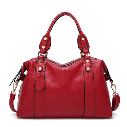 Red handbag with gold accents on a white background