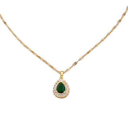 Gold necklace with a green gemstone pendant on a white background