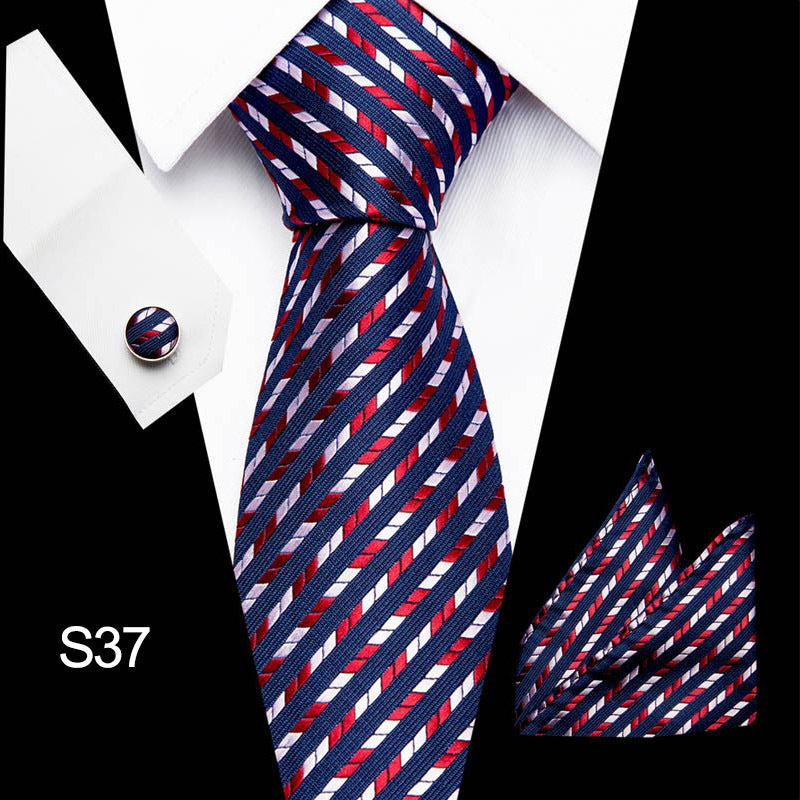 Navy, red, and white striped tie with matching pocket square on a suit.