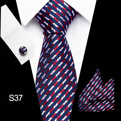 Navy, red, and white striped tie with matching pocket square on a suit.