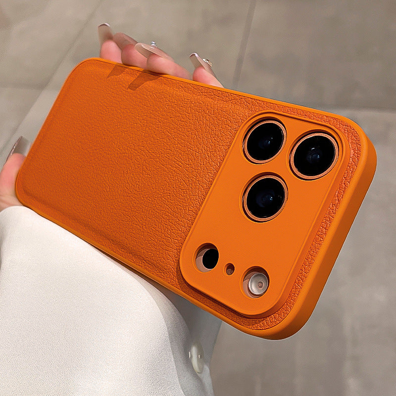 Orange phone case held by a person with a blurred background