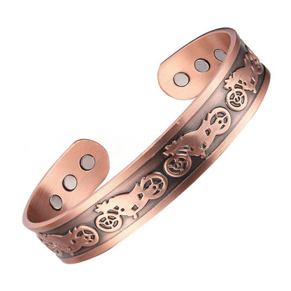 Copper bracelet with intricate designs on a white background