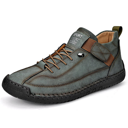 Men's mid-top leather lace-up shoe in gray with brown accents and rugged stitched outsole.
