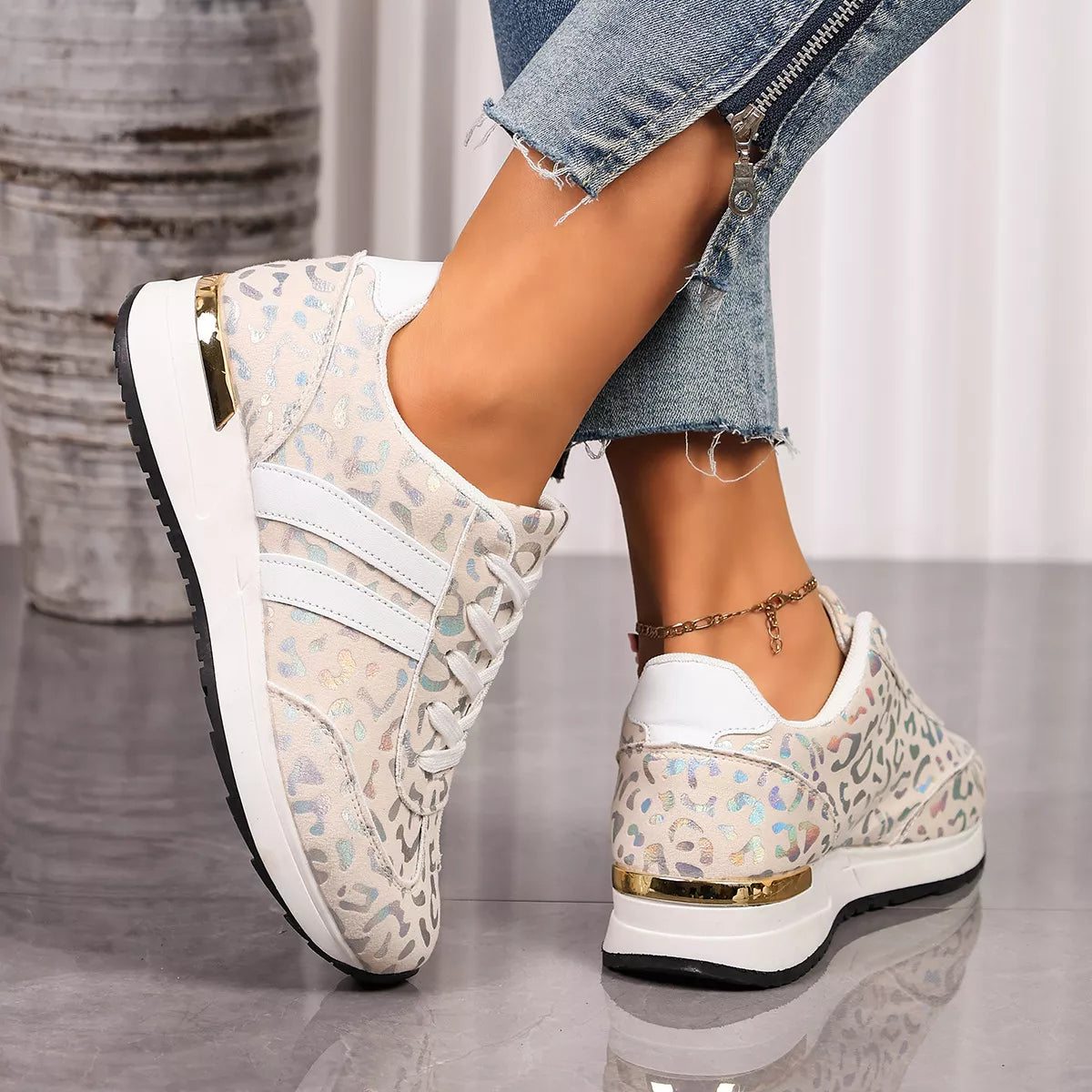 Leopard print lace-up sneakers, white side straps, and back heel tab on black sole