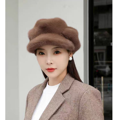 Woman wearing a brown fur hat and coat against a light background