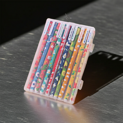 Set of colorful pens in a transparent case on a metallic surface