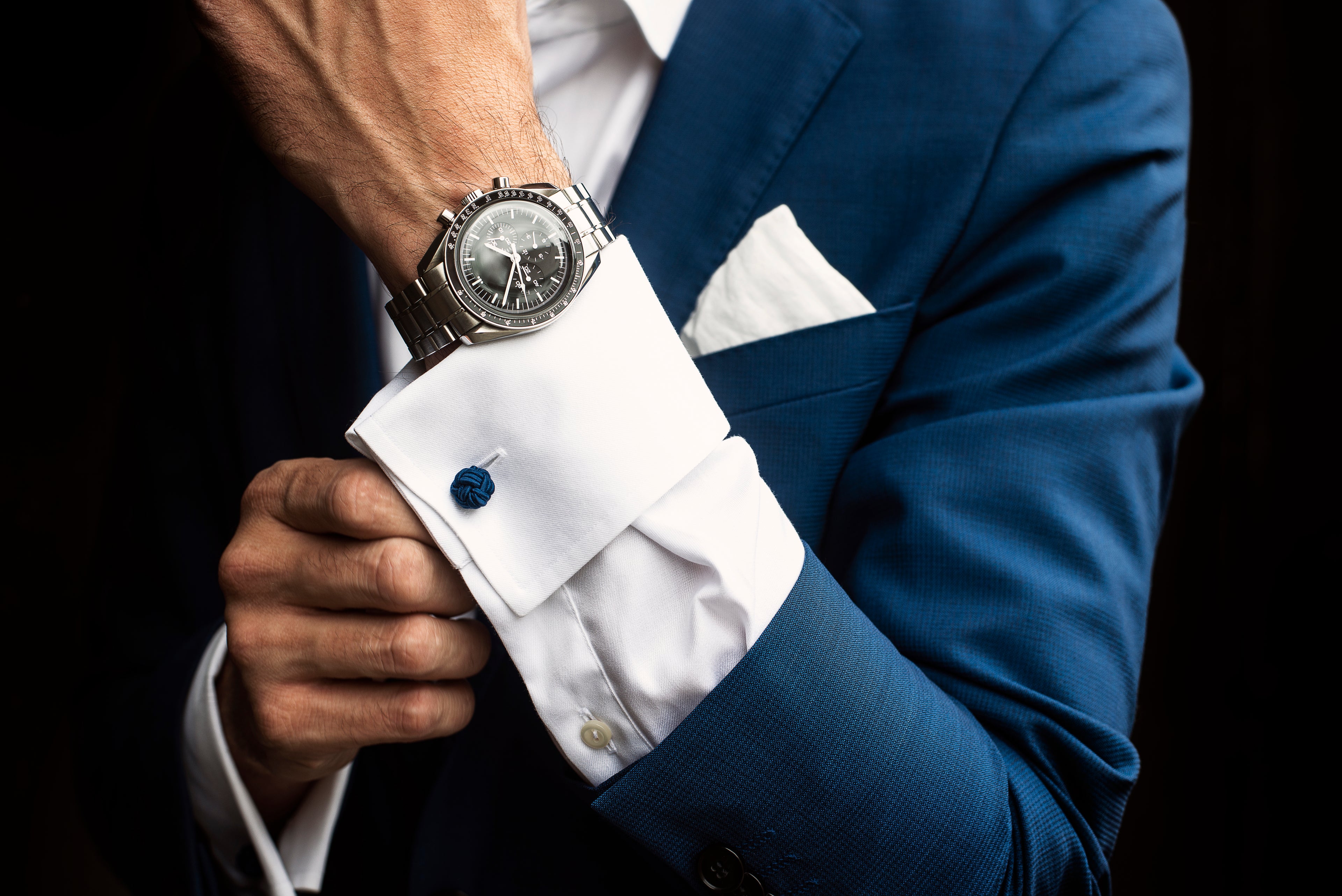 Man adjusting shirt cuffs below wristwatch – YAXSO men’s fashion