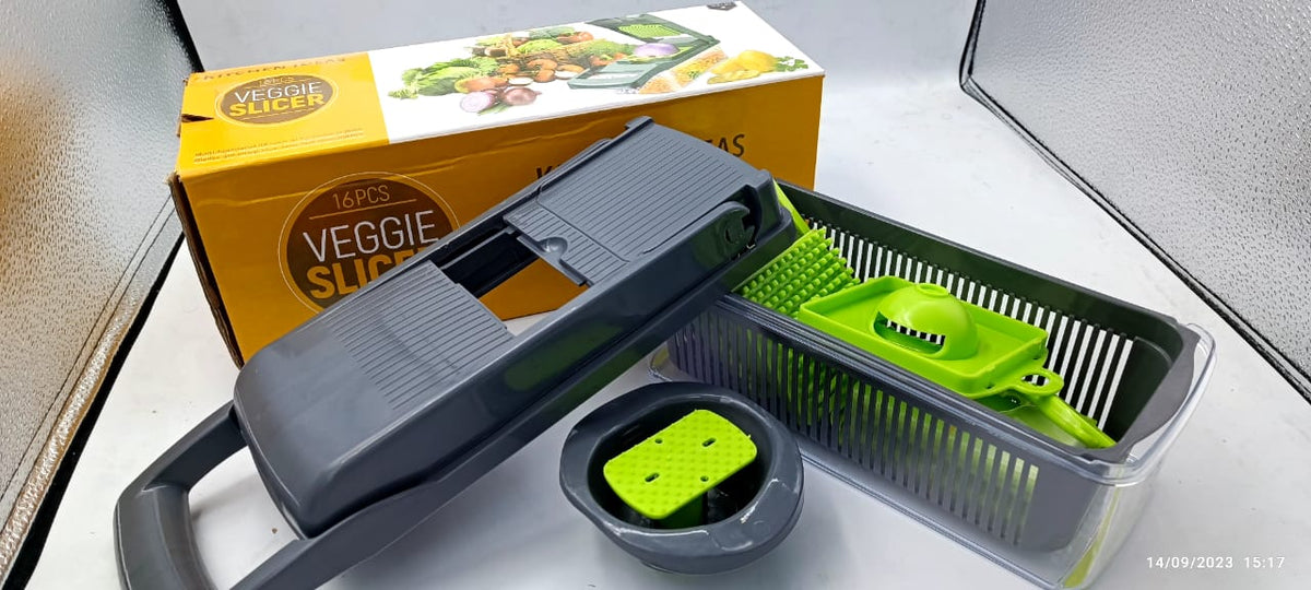 Multi-blade vegetable chopper and slicer with gray housing, green blade insert, container