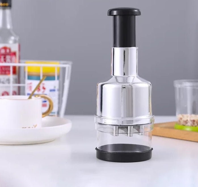 Compact manual press chopper with black top handle and clear cutting chamber