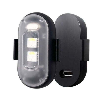 Pair of black wireless LED strobe lights with clear housings and charging port